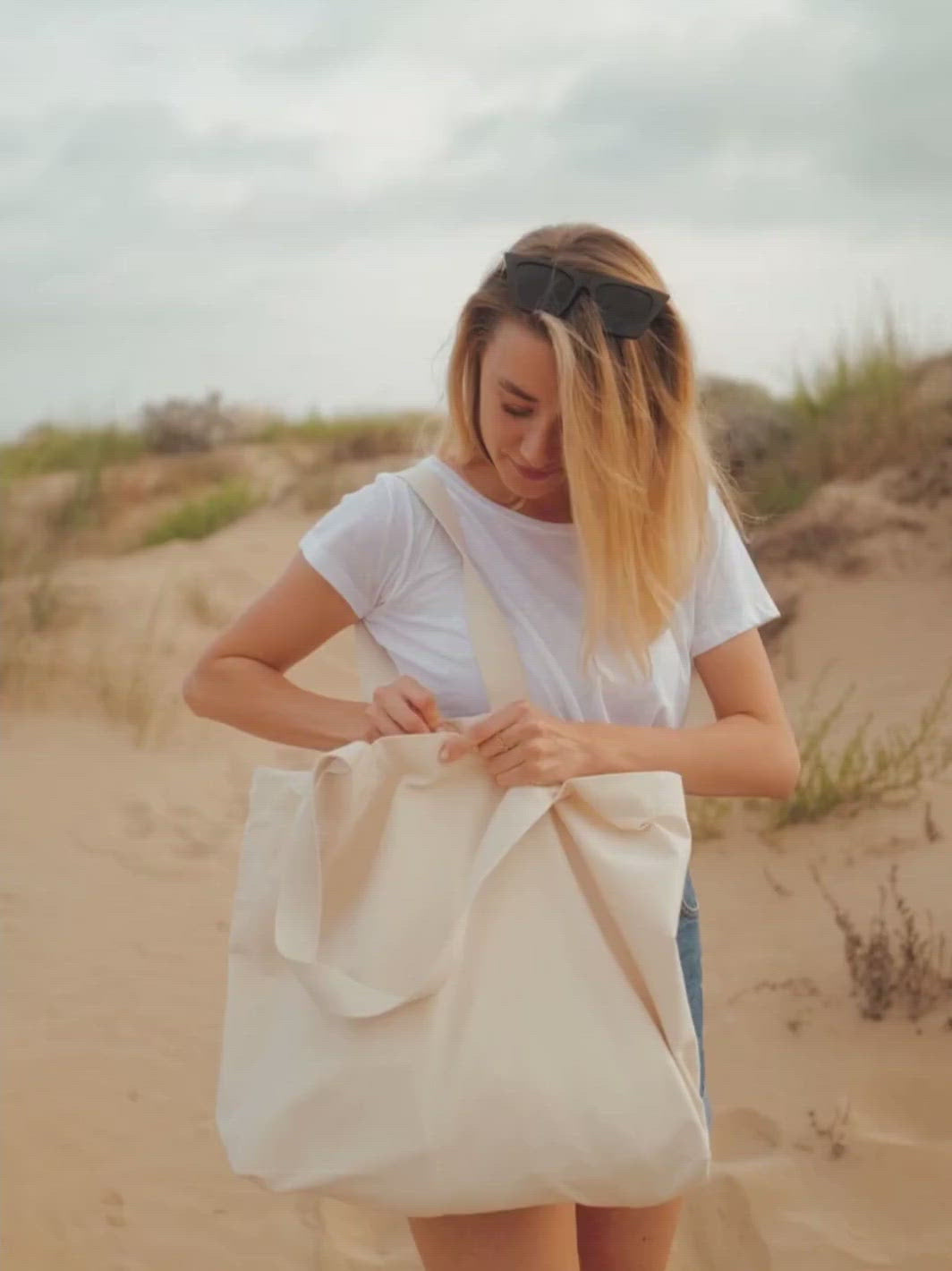 Beach plátěná taška z biobavlny přírodní nebarvená žena v písečných dunách si zapíná tašku