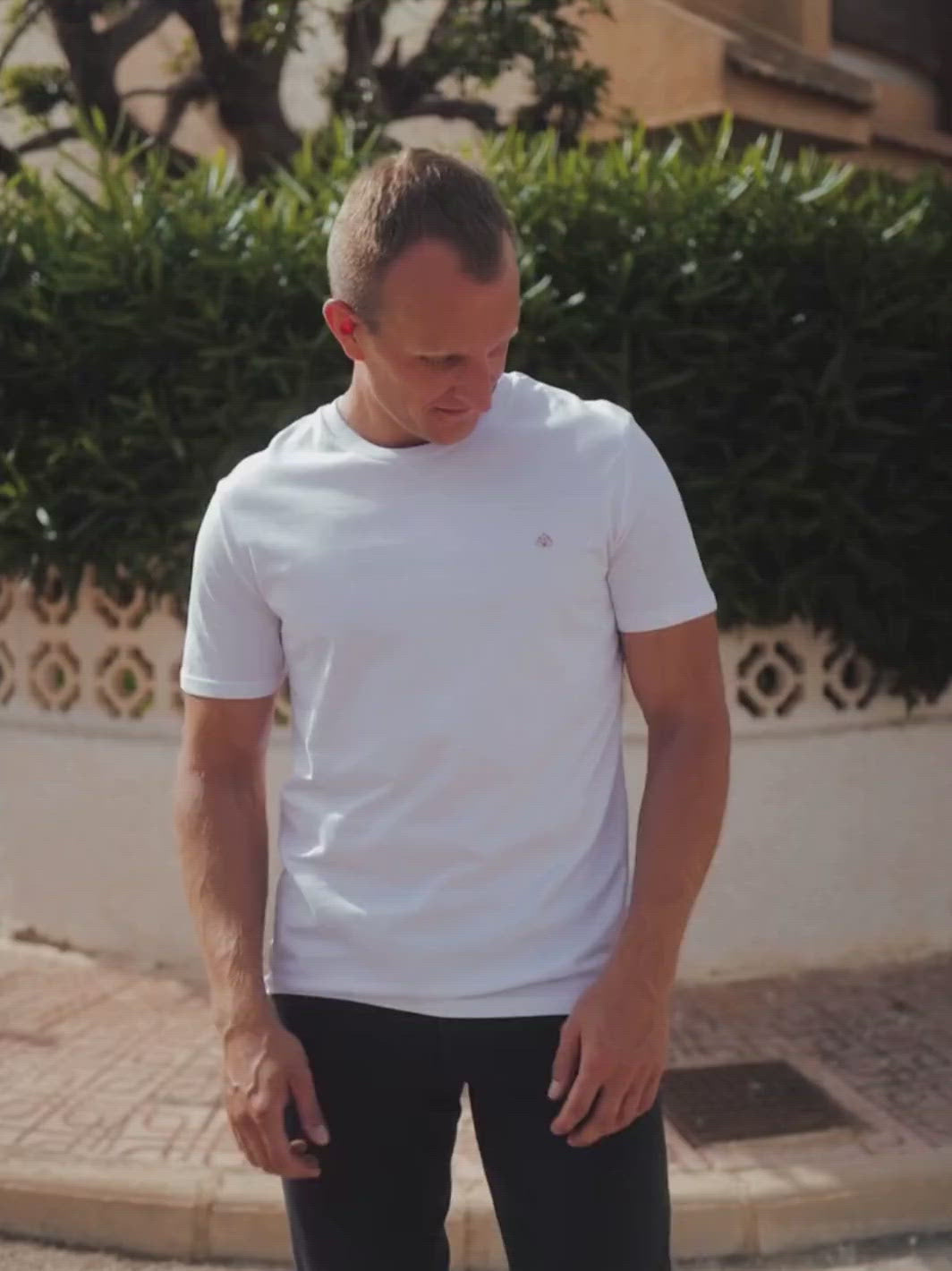 Feel pánské tričko z biobavlny s kulatým výstřihem bílé muž na křižovatce si upravuje tričko